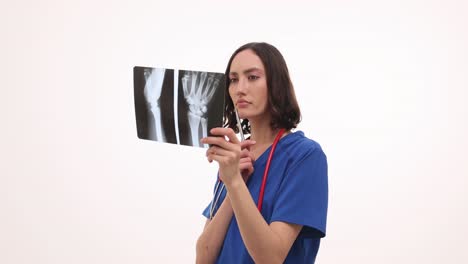 female medical professional examining hand x-ray