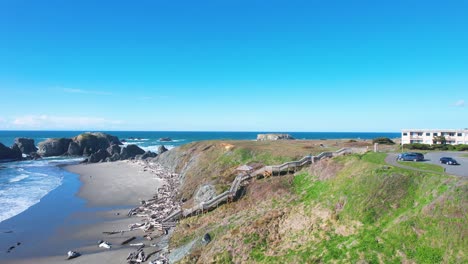 beautiful 4k aerial shot hovering towards beach staircase in bandon, oregon beach on a sunny day