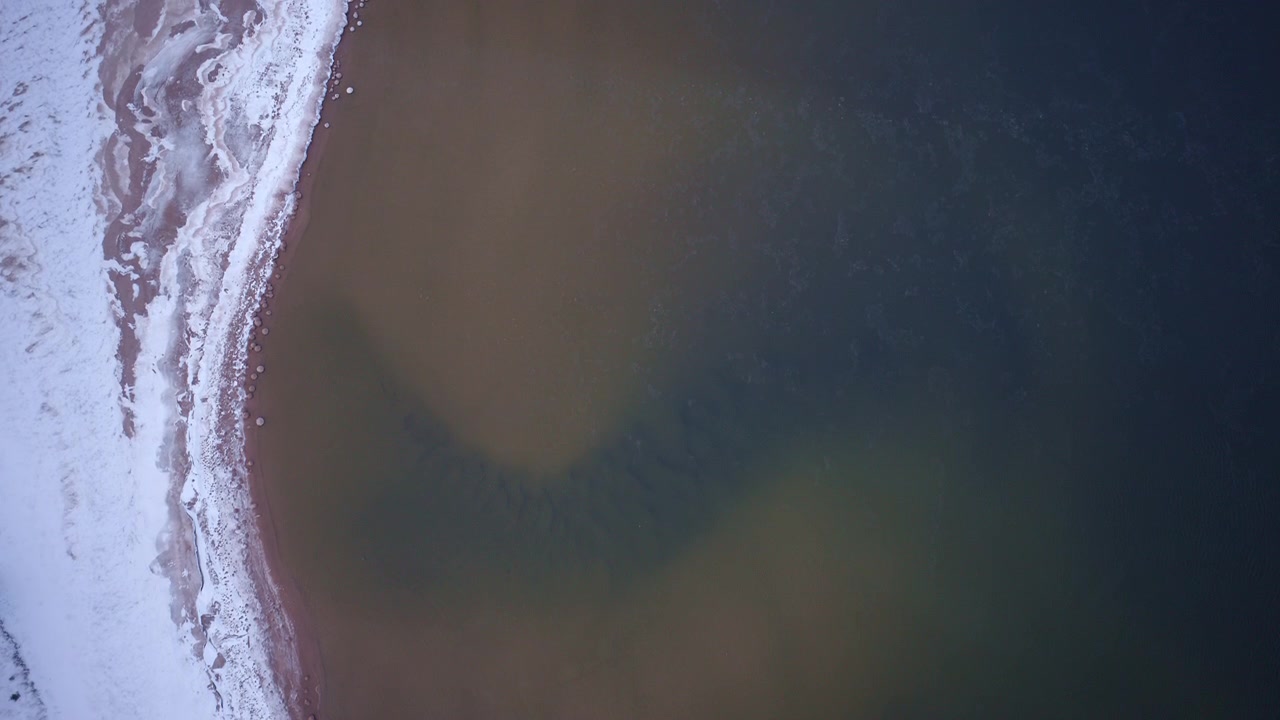 Drone shot of the Lake Superior coastline in Northern Michigan during winter