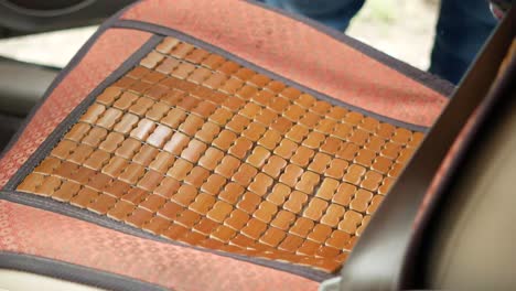 cleaning a car seat cushion with a red cloth