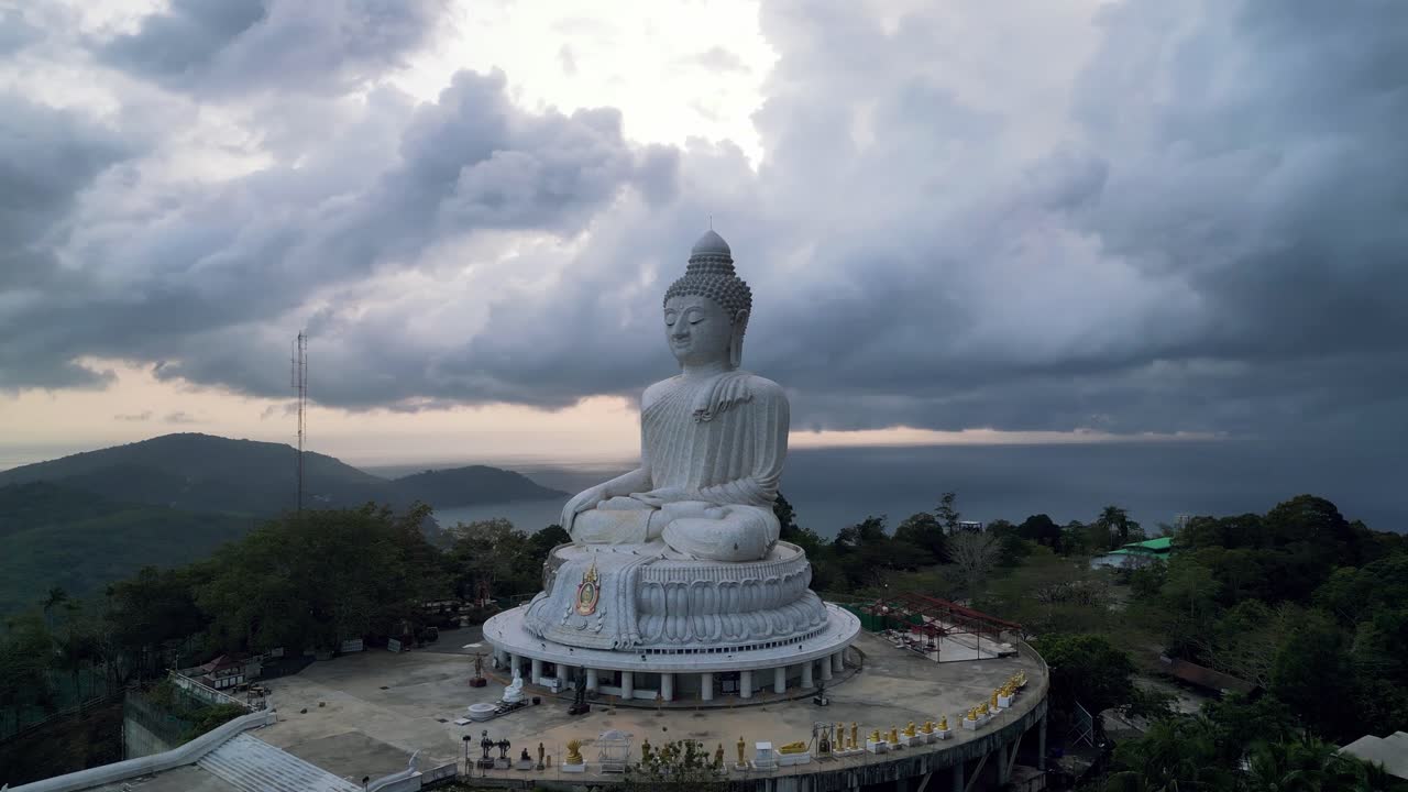 Big Buddha statue in Phuket with dramatic skies and panoramic sea and mountain backdrops