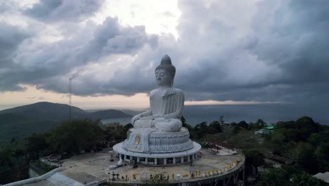 big buddha statue in phuket with dramatic skies and panoramic sea and mountain backdrops