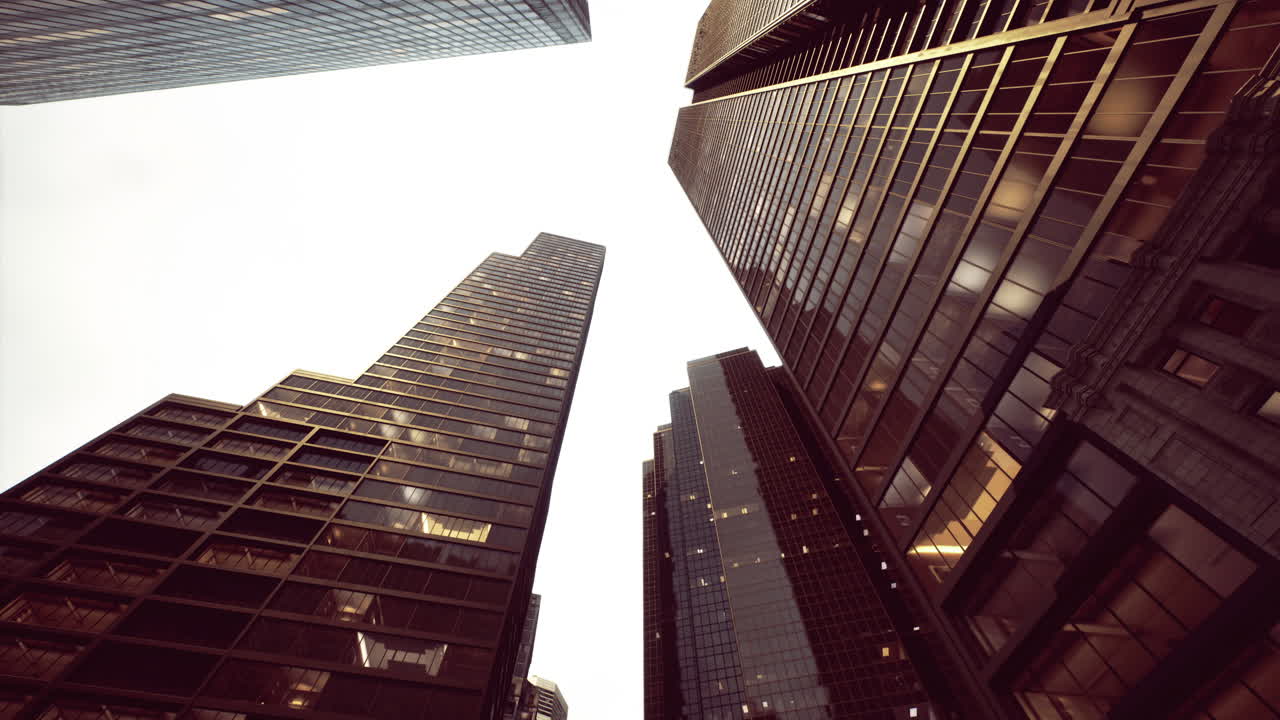 Urban landscape showcasing towering buildings under a cloudy sky at dusk