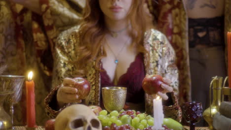 enchanting witchcraft: redheaded sorceress at table with skull and wine