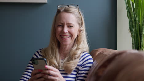 woman using smartphone indoors