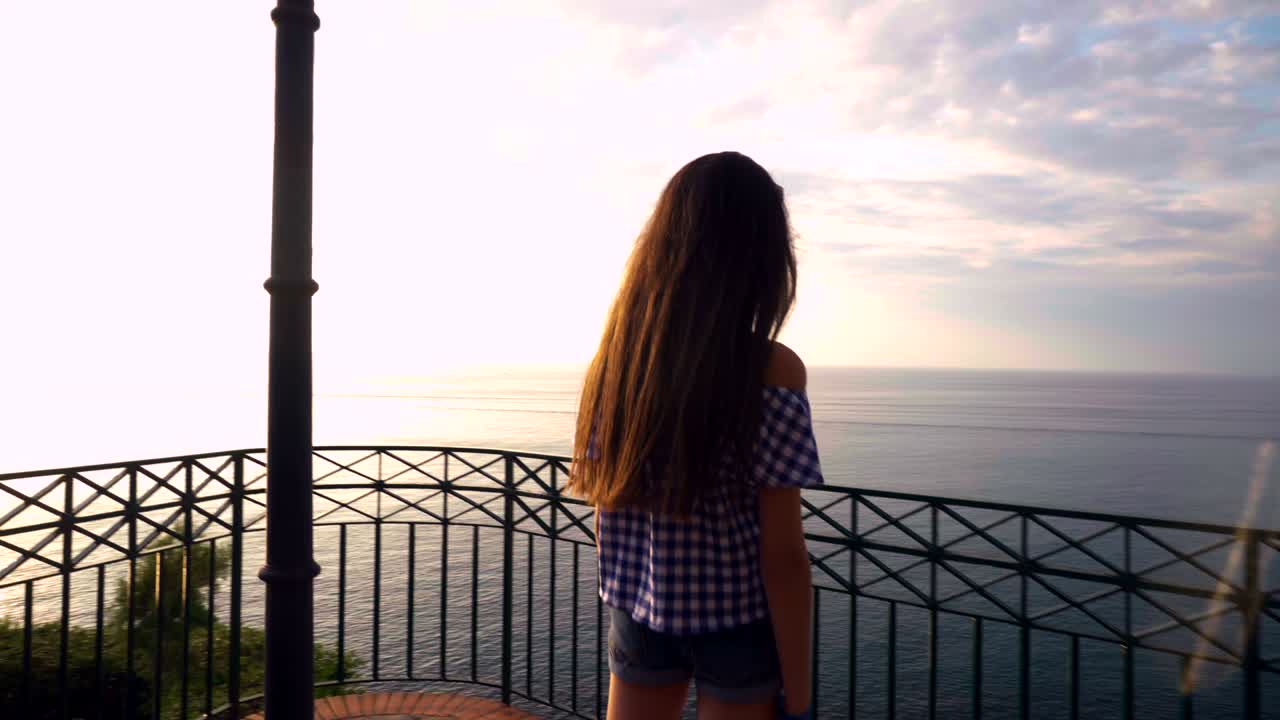 Little girl looks at the the sunset on the sea, Italy,lookout, Calabria , Summer,Tropea