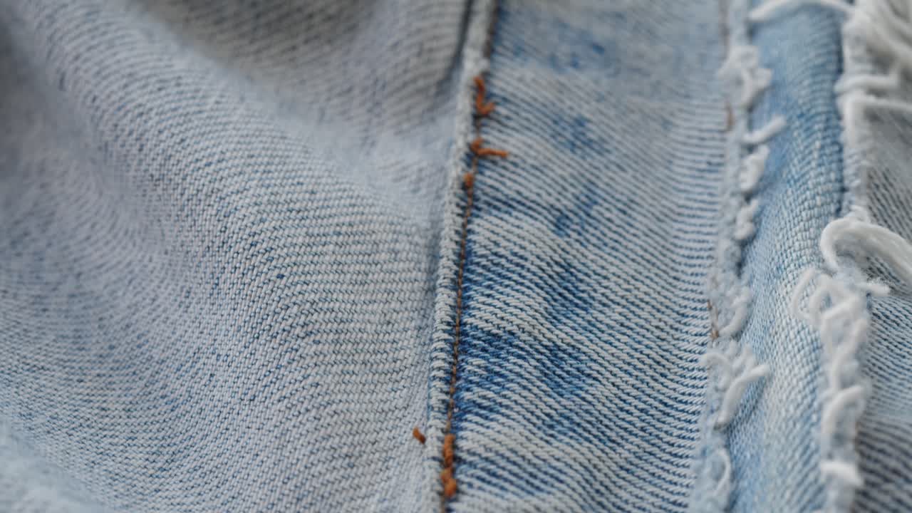 Macro Shot of Blue Denim Jeans Fabric with Orange Stitching