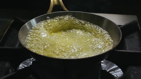 chef is melting the butter on hot frying pan on the stove