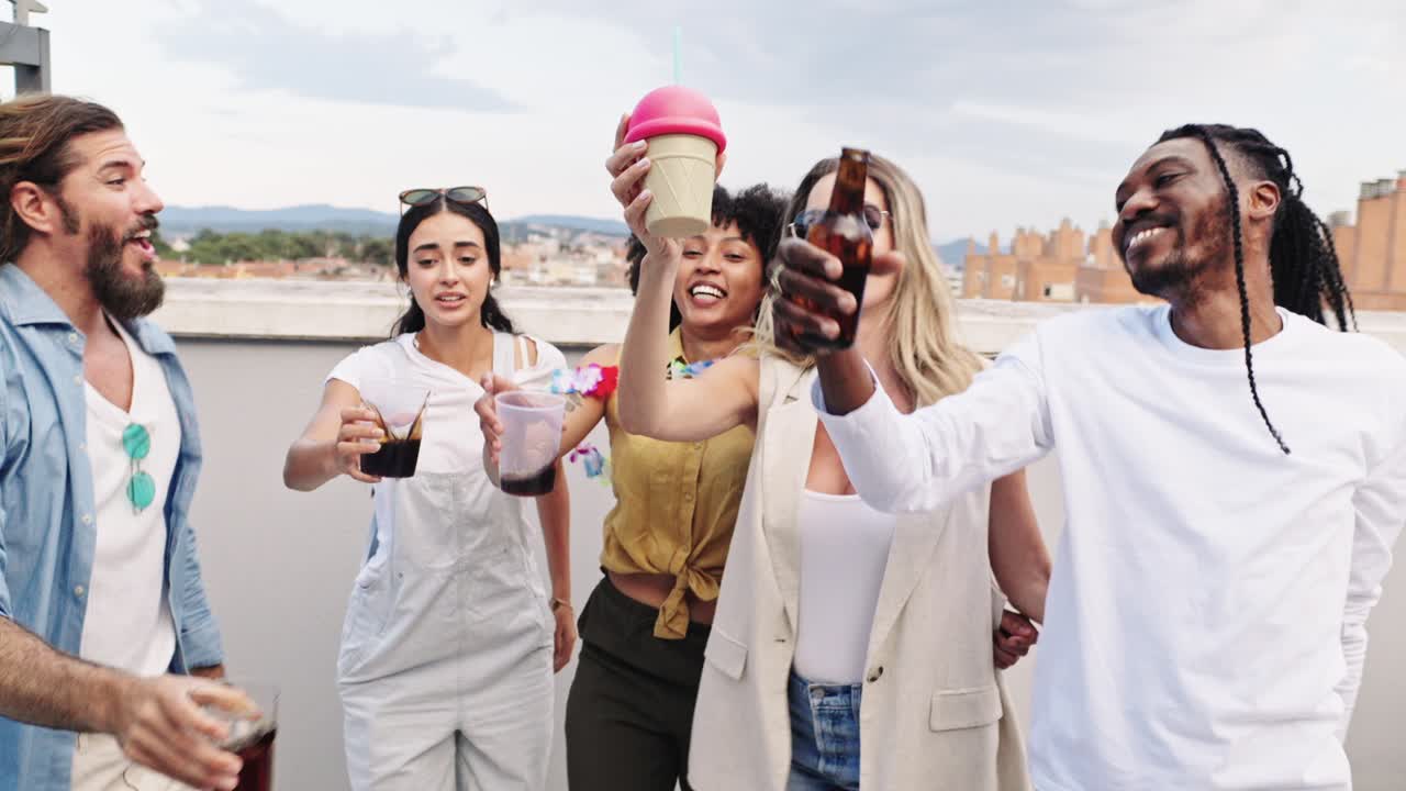 Group of friends celebrating and having drinks on a rooftop