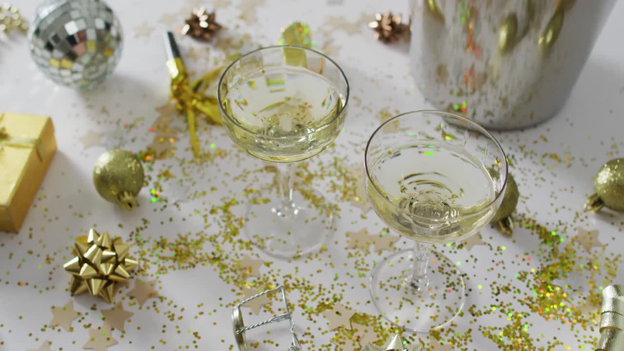 Champagne glasses and decorations on white background at new year's eve