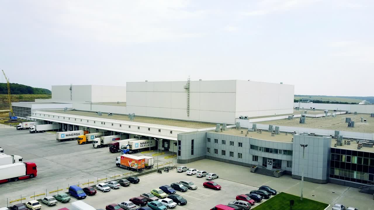 Gray facade made of aluminum panels with doors and windows on industrial building