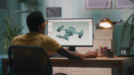 person designing a drone model on a computer