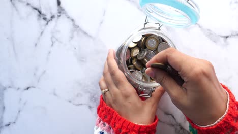 saving coins in a glass jar