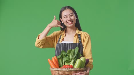 woman holding basket of vegetables