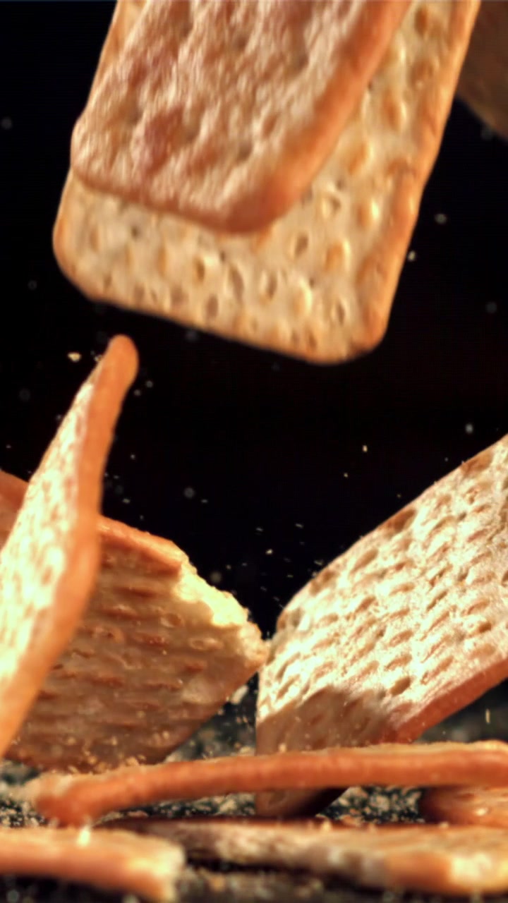 Slow Motion of Crackers Falling and Breaking into Crumbs