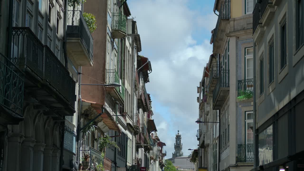 Static shot of a church at the end of a street with buildings on the sides.