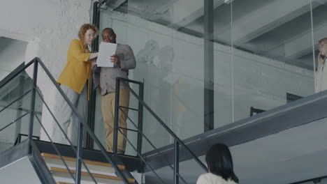 business people meeting on stairs in a modern office