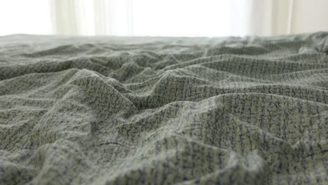 close up of wrinkled sheets on a bed