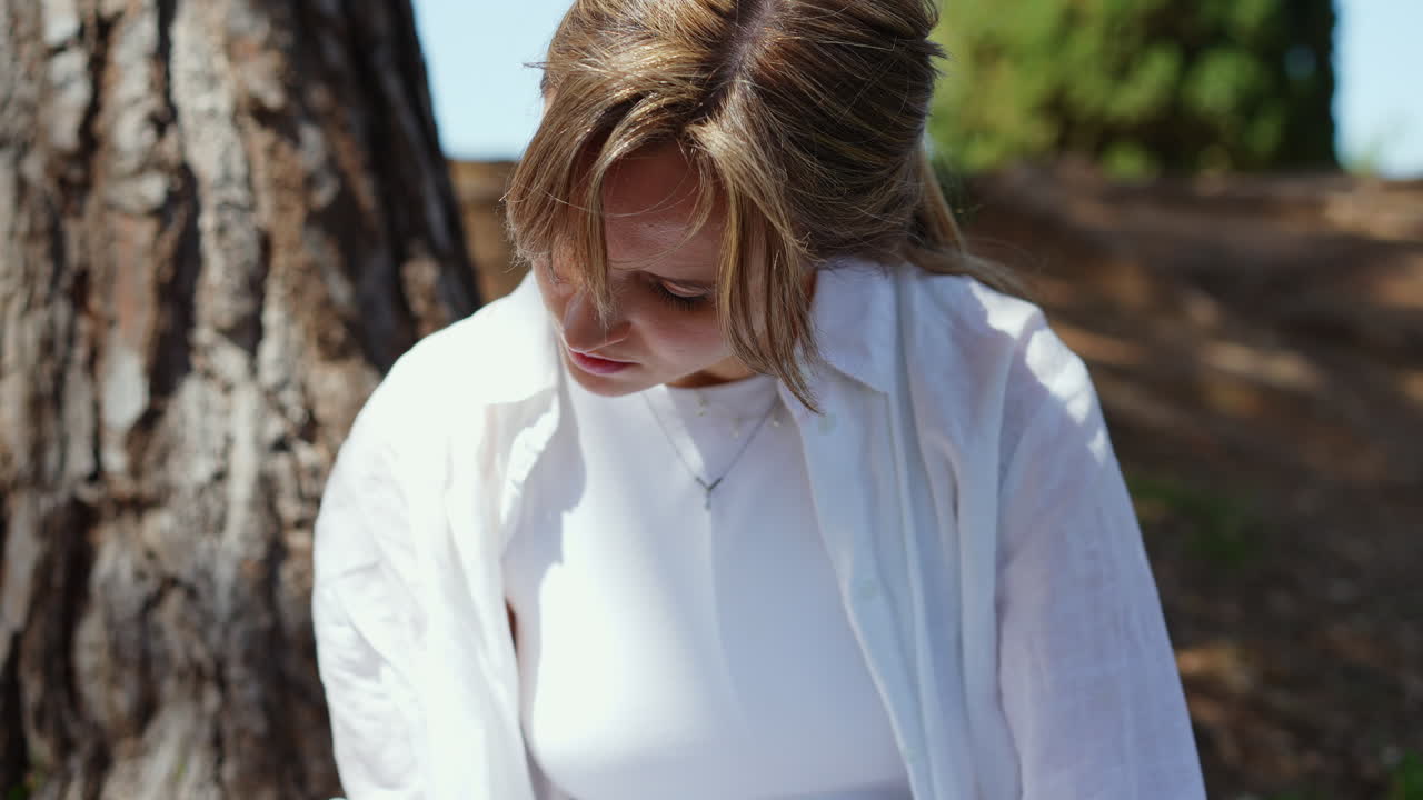 Woman Sitting Under a Tree