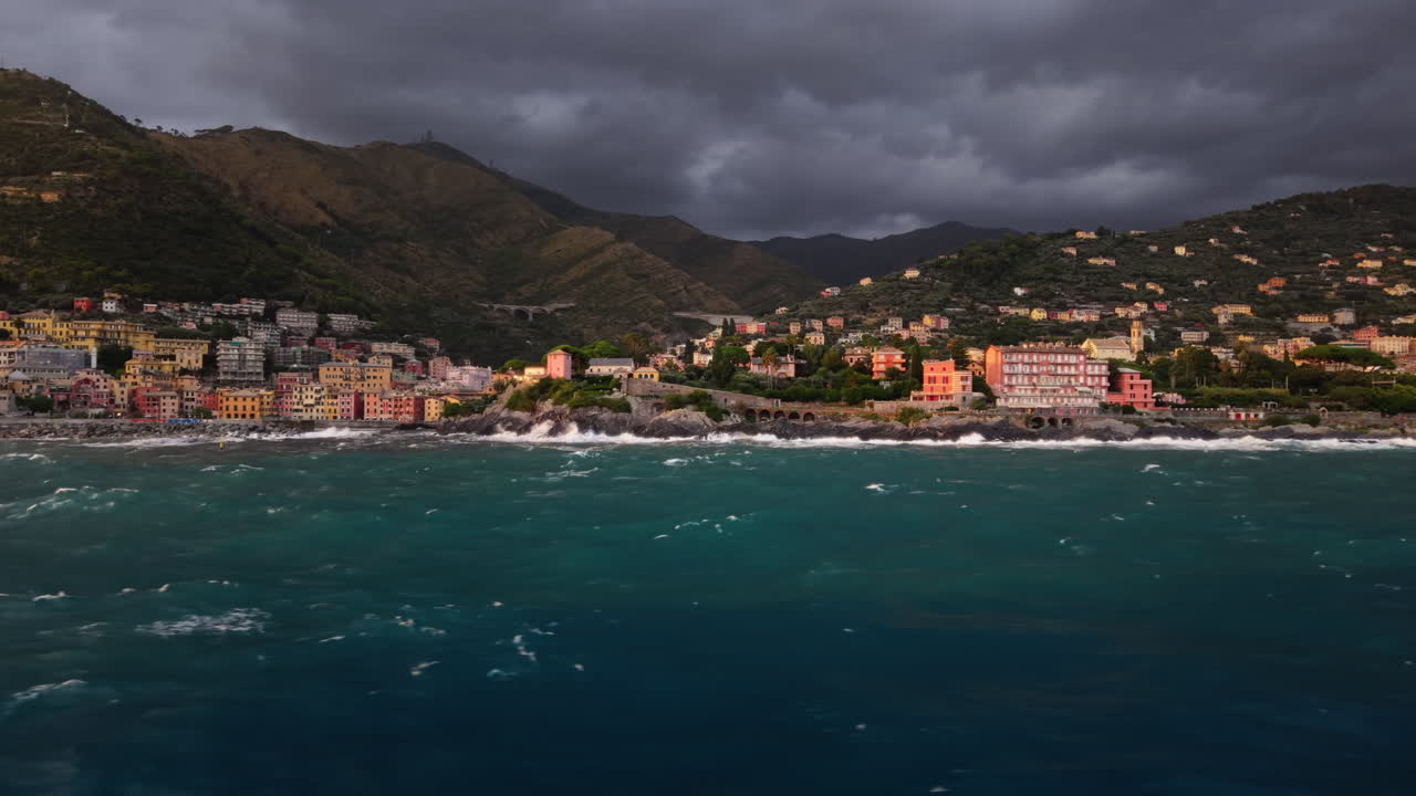 Stormy seaside village view, mountains, slow-motion waves