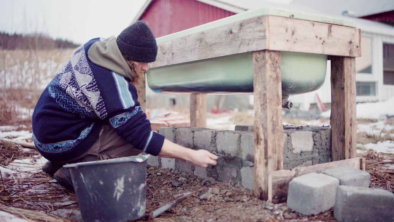 Man Building DIY Hot Tub Outdoor. closeup shot