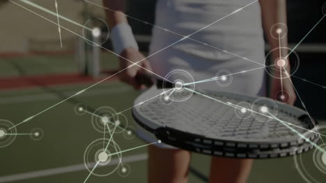 tennis player balancing tennis ball above racket on green court showing technology network graphics