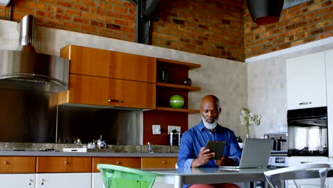 hombre mayor usando tableta digital en la cocina 4k