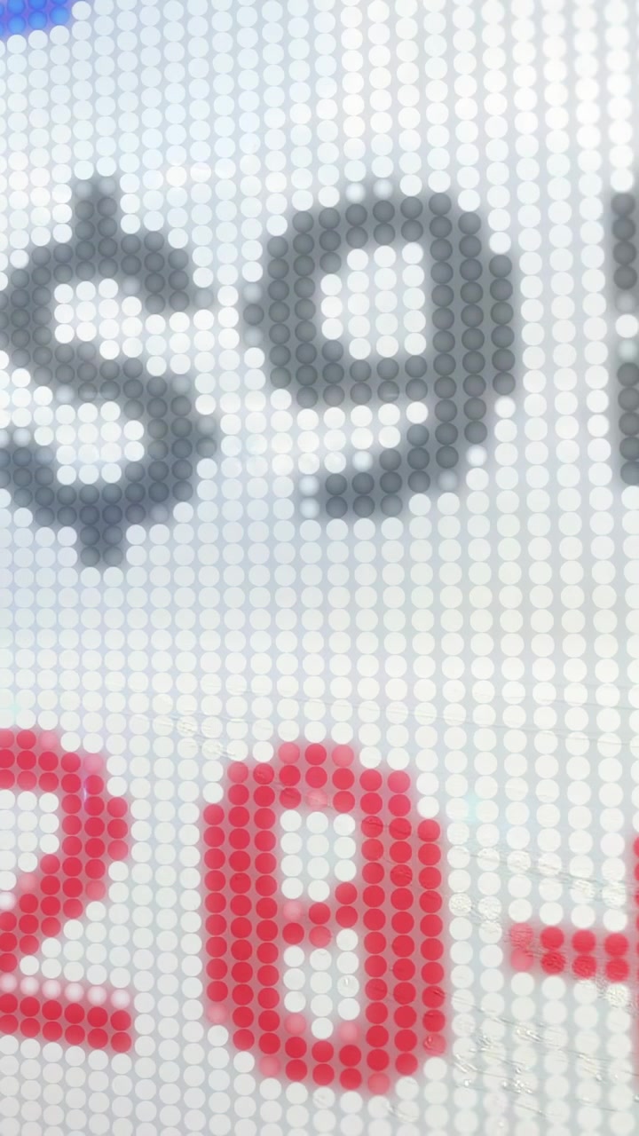 Vertical video: Hand cam starting on plus panning LED revealing gray-red digits for pixel detail