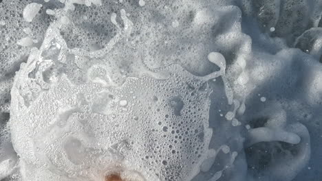 feet of a woman walking along the waters edge