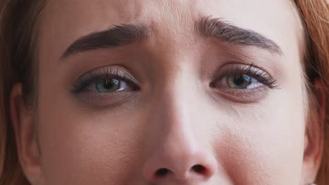 close-up of a woman looking sad and crying