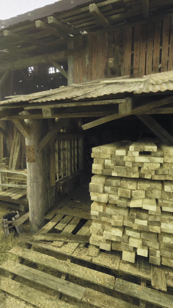 Old wooden structure with stacked lumber in a desert setting