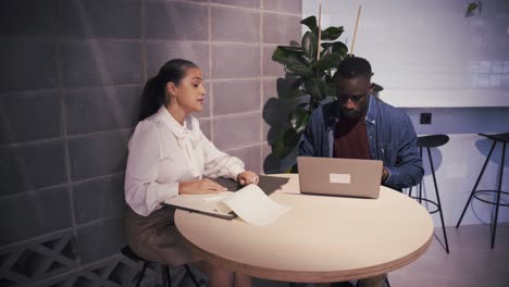 couple of colleagues with laptop discussing project