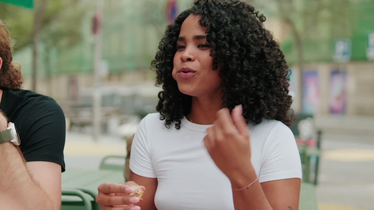 Lunch communication. International joyful students eating, talking and laughing