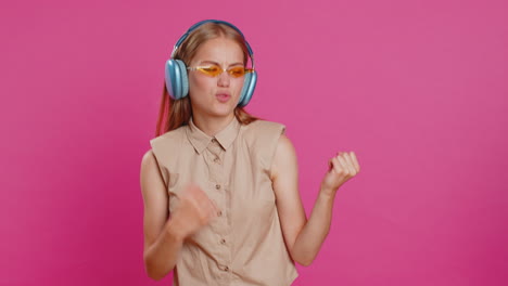 Happy-young-woman-in-headphones-listening-music-dancing-disco-having-fun-relaxing-on-christmas-party