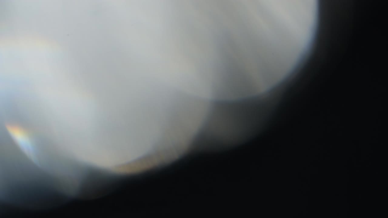 Abstract light leaks on black background.