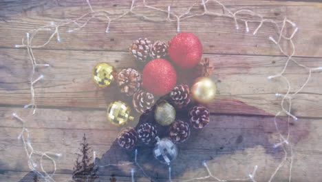 animación de la decoración navideña con bolas y conos de pino sobre un paisaje de invierno