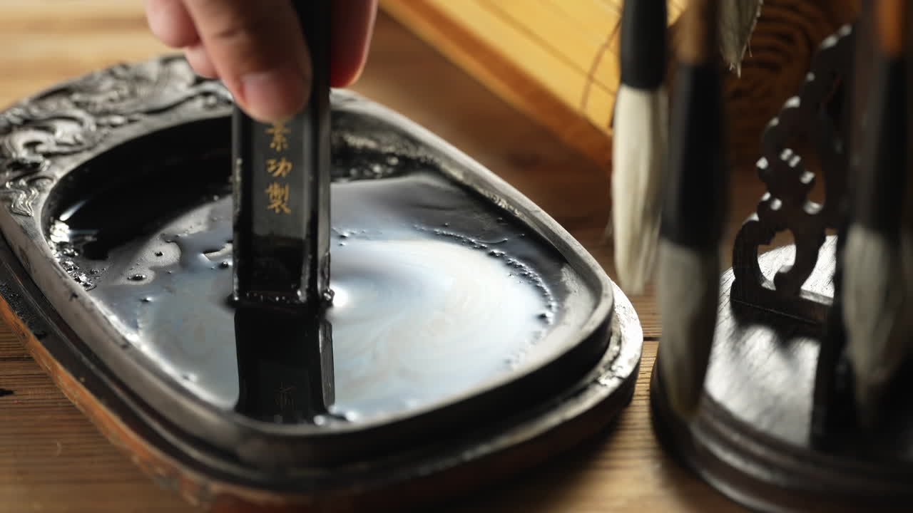 The grinding Inkstone Ink process traditional Chinese being prepared by an artist before paint Chinese calligraphy brush ready to use