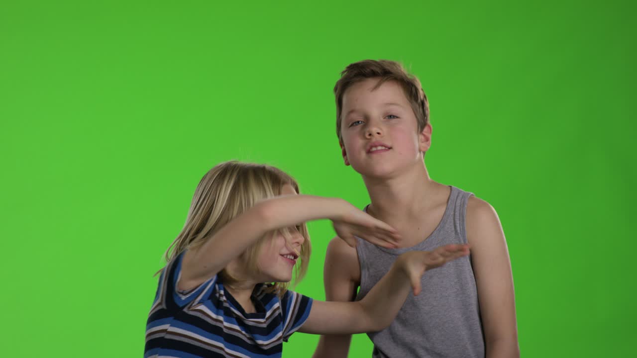 Brothers playing together in front of greenscreen