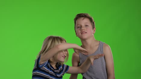 brothers playing together in front of greenscreen