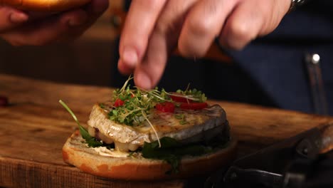 chef preparing a gourmet fish burger