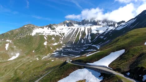 aerial shot of nufenenpass and surrounding mountains in the swiss alps