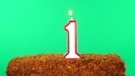 cake with the number 1 lighted candle. chroma key. green screen. isolated