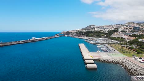 drone aerial pan right view of atlantic ocean and the harbor in funchal city, madeira island in portugal