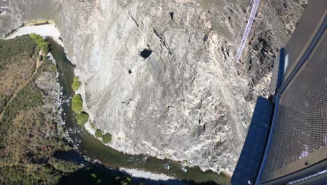 watching a bungy jumper jump from the cable car at nevis bungy jump in queenstown new zealand