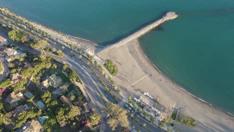 Aerial-view-of-peninsula-in-the-sea-and-a-road-along-the-shoreline