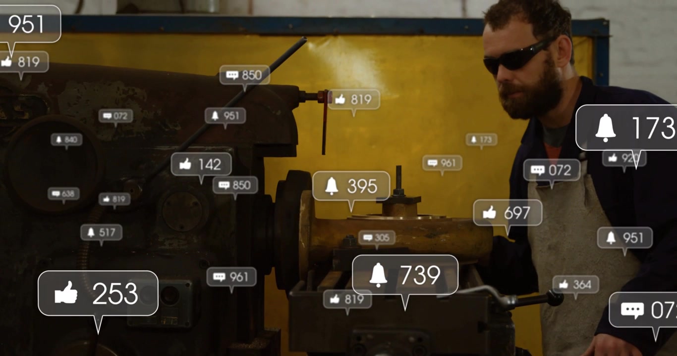 Vertical video: Worker watching lathe as alerts growing over lathe, tracking interest in metal shop
