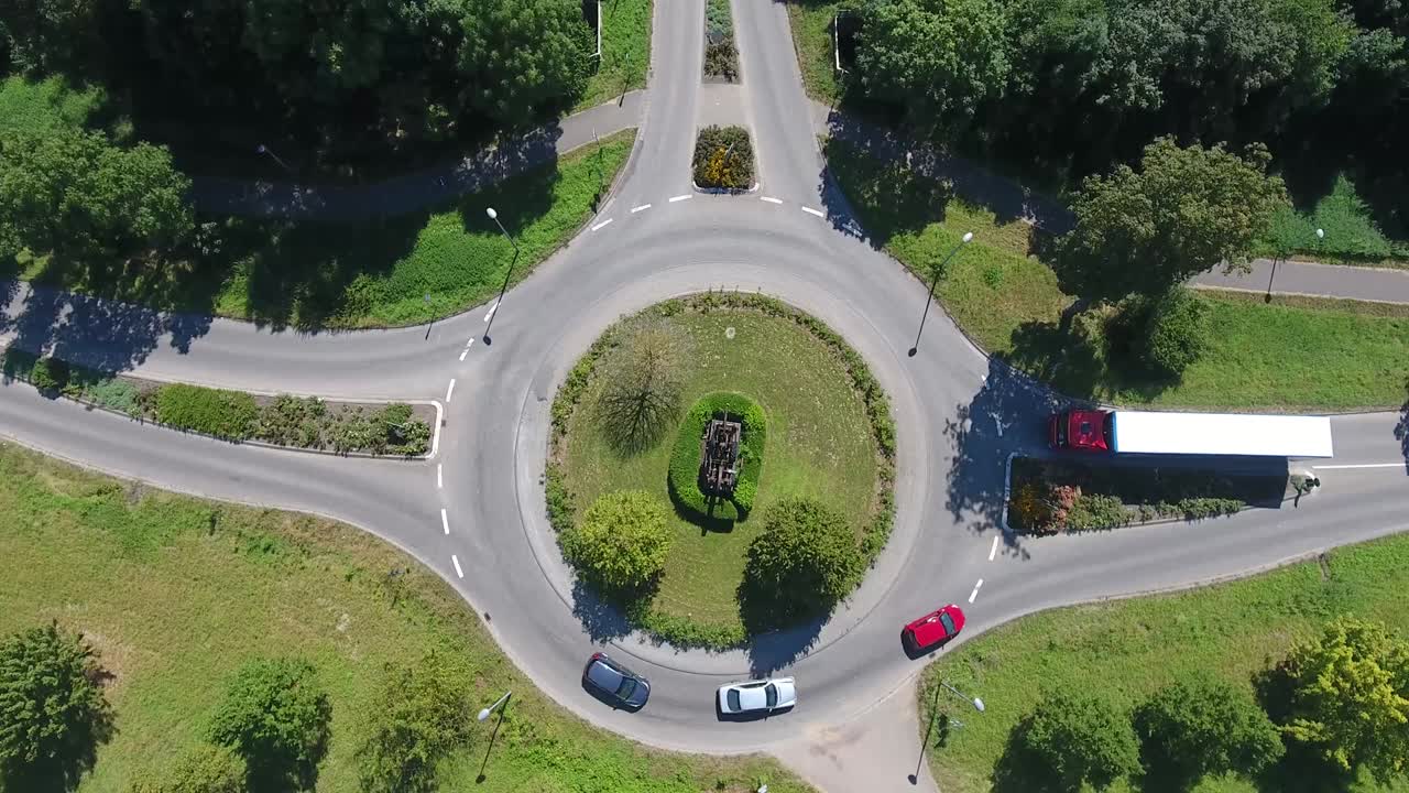 little traffic circle roundabout with driving cars