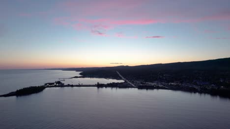 drone shot of a colorful sunset with active boat harbor