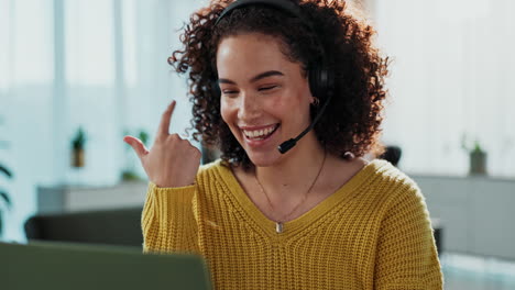 woman with curly hair wearing a headset during a virtual meeting