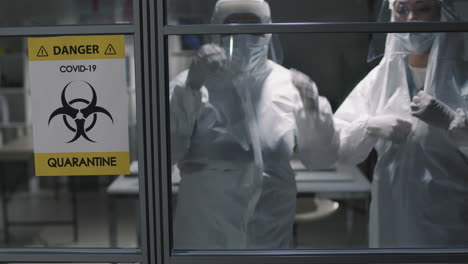 doctors in protective costumes in covid-19 zone